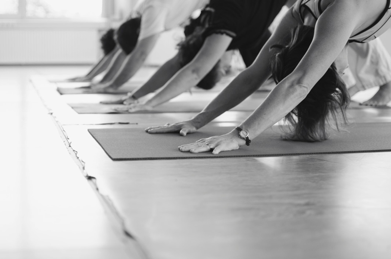 People doing yoga in a class. Black and white.